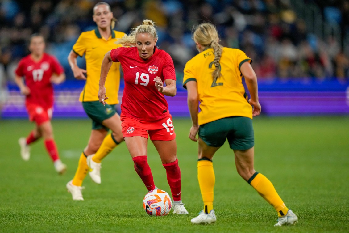 Adriana Leon dribbles past Australia players during a 2022 friendly match