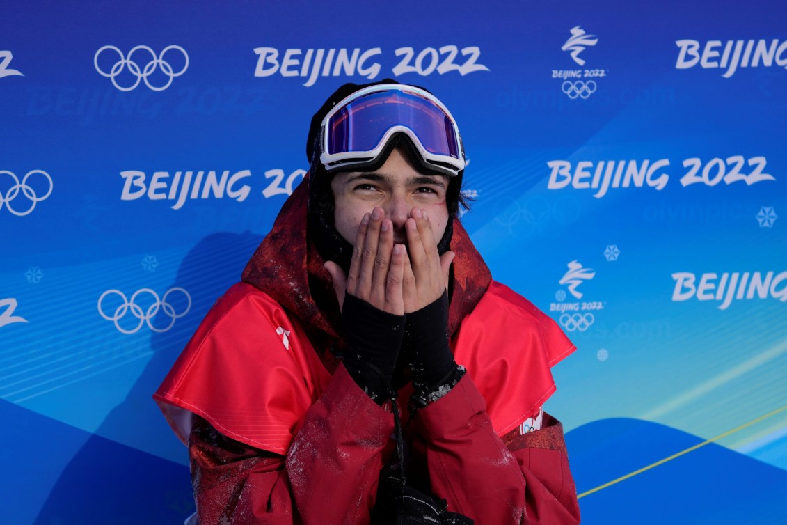 Liam Gill holds his hands up to his mouth as he awaits his score in the finish area