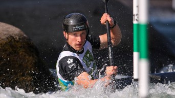 Mael Rivard paddles his kayak through a whitewater slalom course