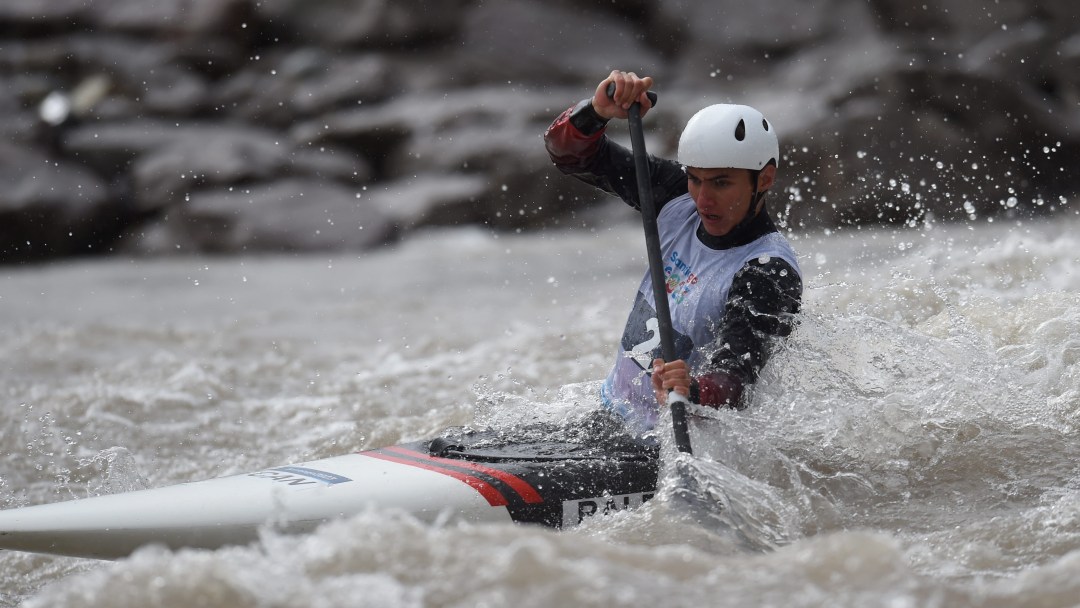 Alex Baldoni paddles his canoe through whitewater