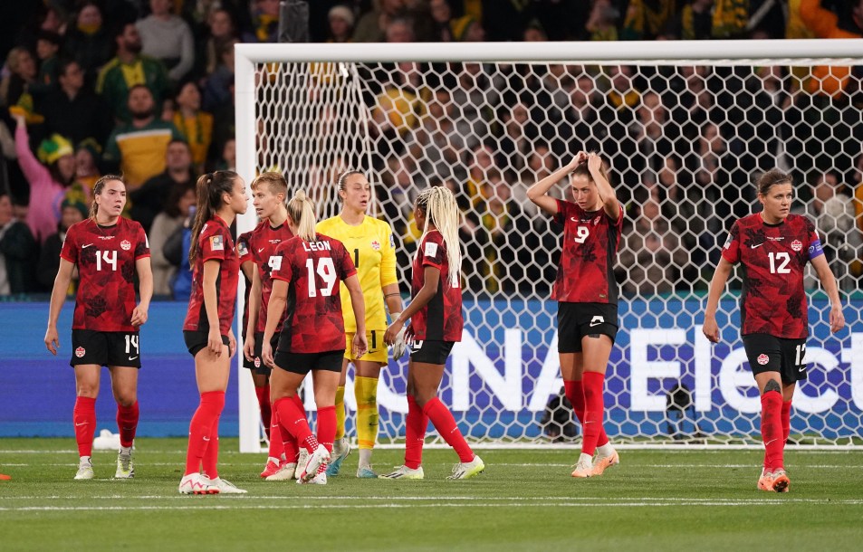 Canada players react after conceding a goal to Australia.
