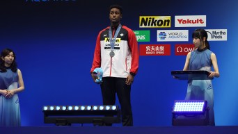 Josh Liendo stands on the podium with his silver medal
