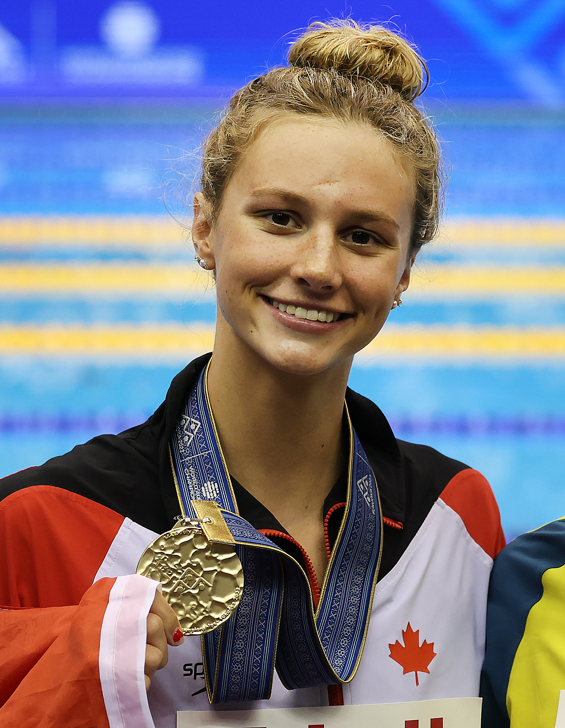 Summer McIntosh wears a gold medal around her neck