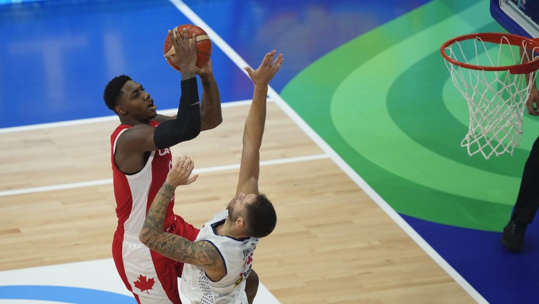 Canada forward RJ Barrett, left, attempts a shot over Serbia guard Stefan Jovic during a Basketball World Cup semi final game in Manila