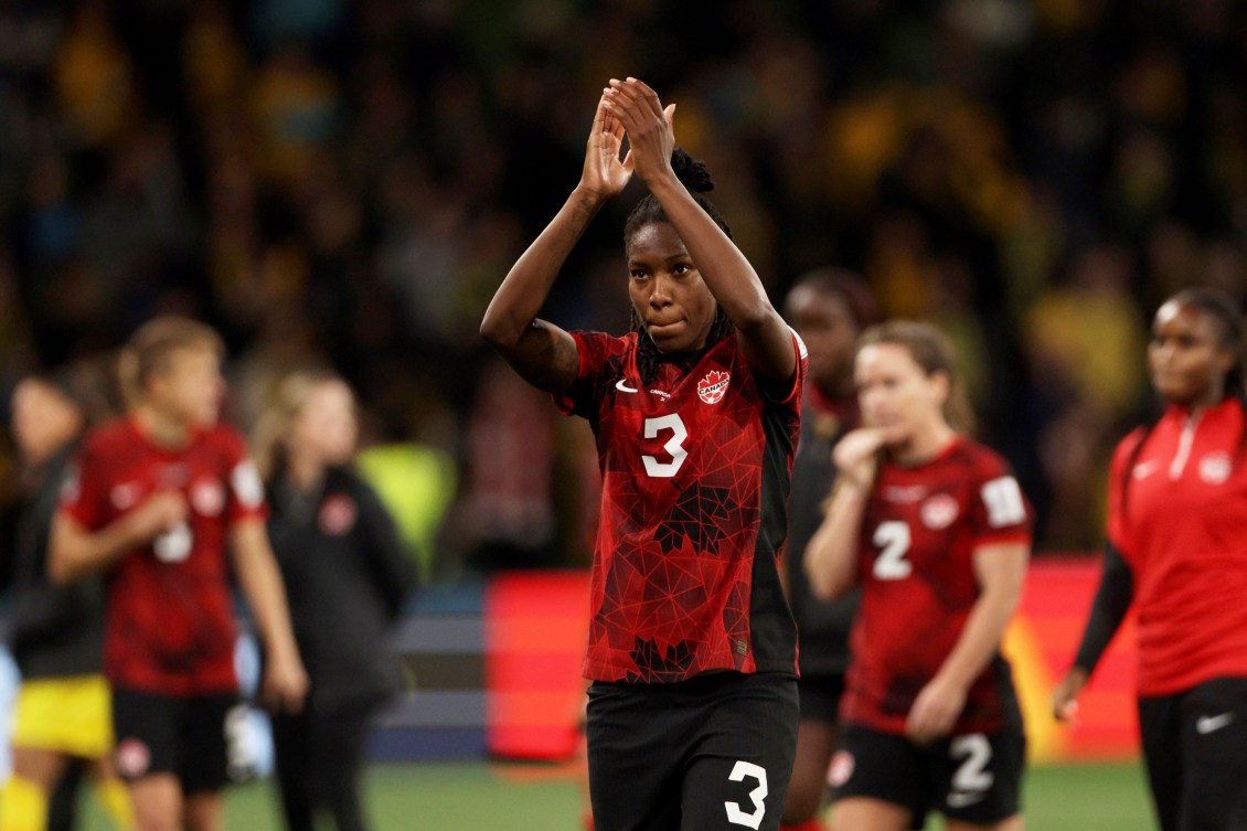 Kadeisha Buchanan claps her hands above her head 