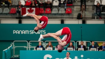 Keegan Soehn and Remi Aubin are mid air in a pike position