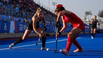 Two field hockey players fight for possession
