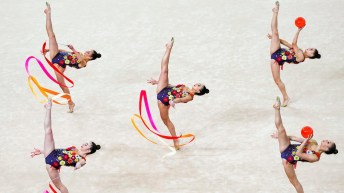 rhythmic gymnasts perform with ribbons and balls
