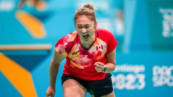 Eliana-ruobing Zhang pumps her fist as she competes in a red Team Canada jersey