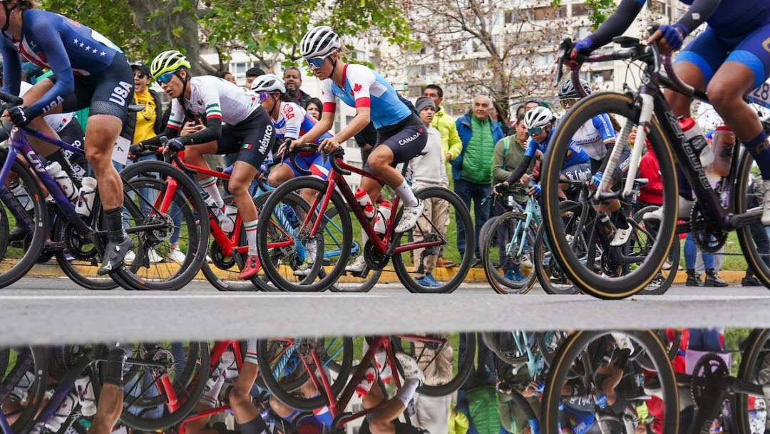 Many female road cyclists in the midst of a race