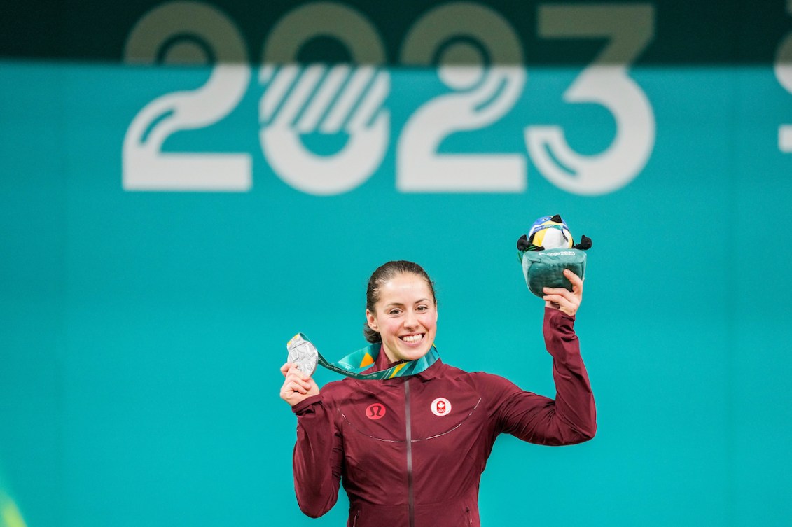 Maude Charron holds up her silver medal and Pan Am mascot on the podium