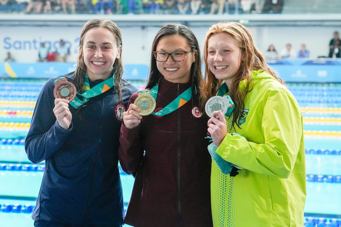 Maggie Mac Neil poses with two other medallists