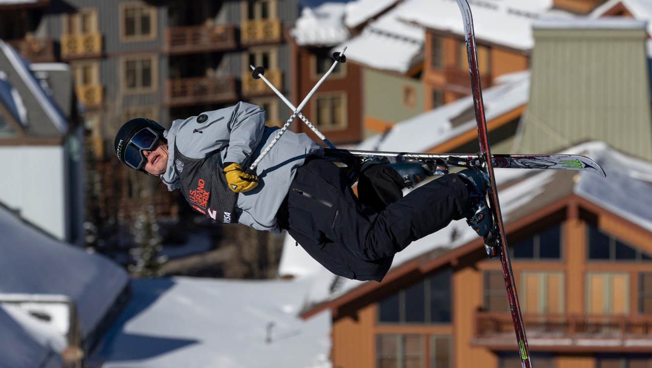 A male halfpipe skier does a trick while competing for Team Canada