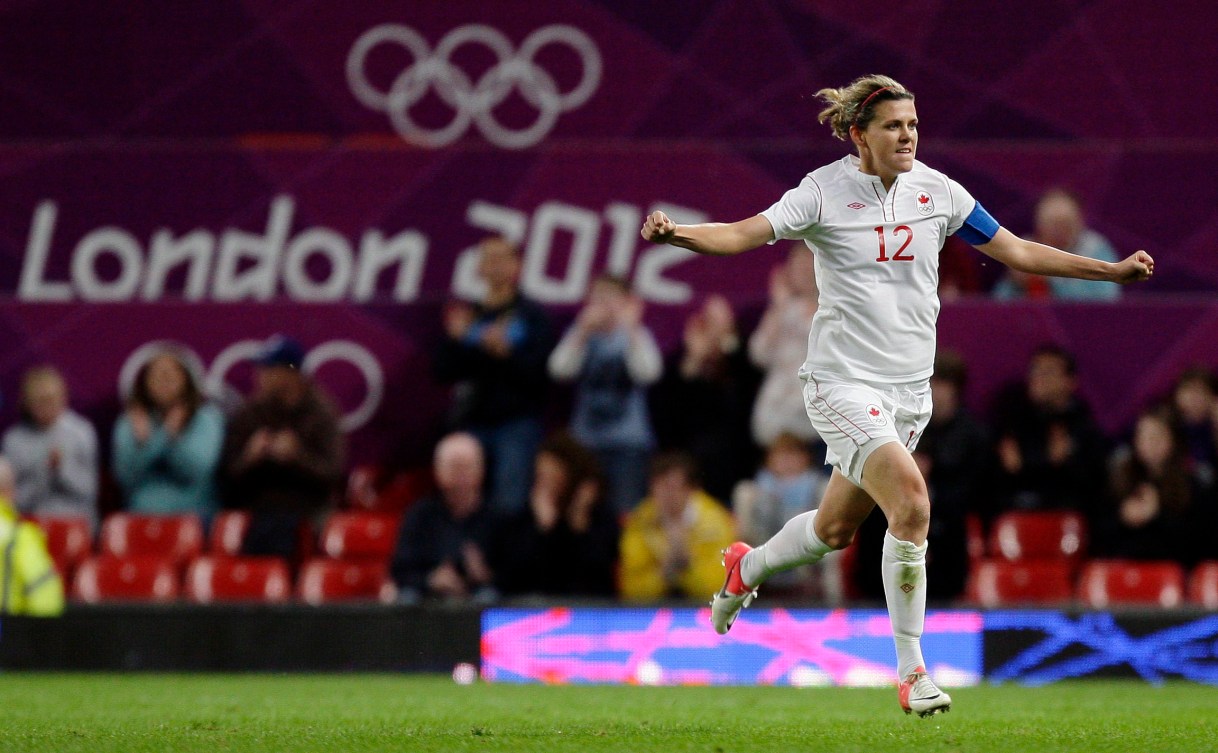 Canada's captain Christine Sinclair celebrates with arms out after scoring her third goal against the United States during their semifinal women's soccer match at the 2012 London Summer Olympics,