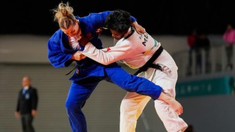 Two judokas grapple while standing