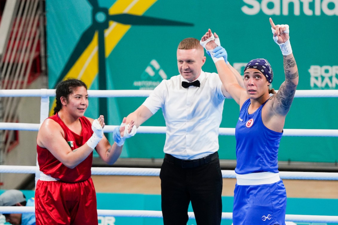 Tammara Thibeault raises her arms in victory while her opponent applauds her