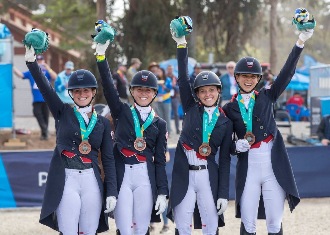 Members of the Canadian dressage team hold bronze medals