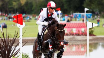 Karl Slezak and his horse jumps over an obstacle in a cross country event