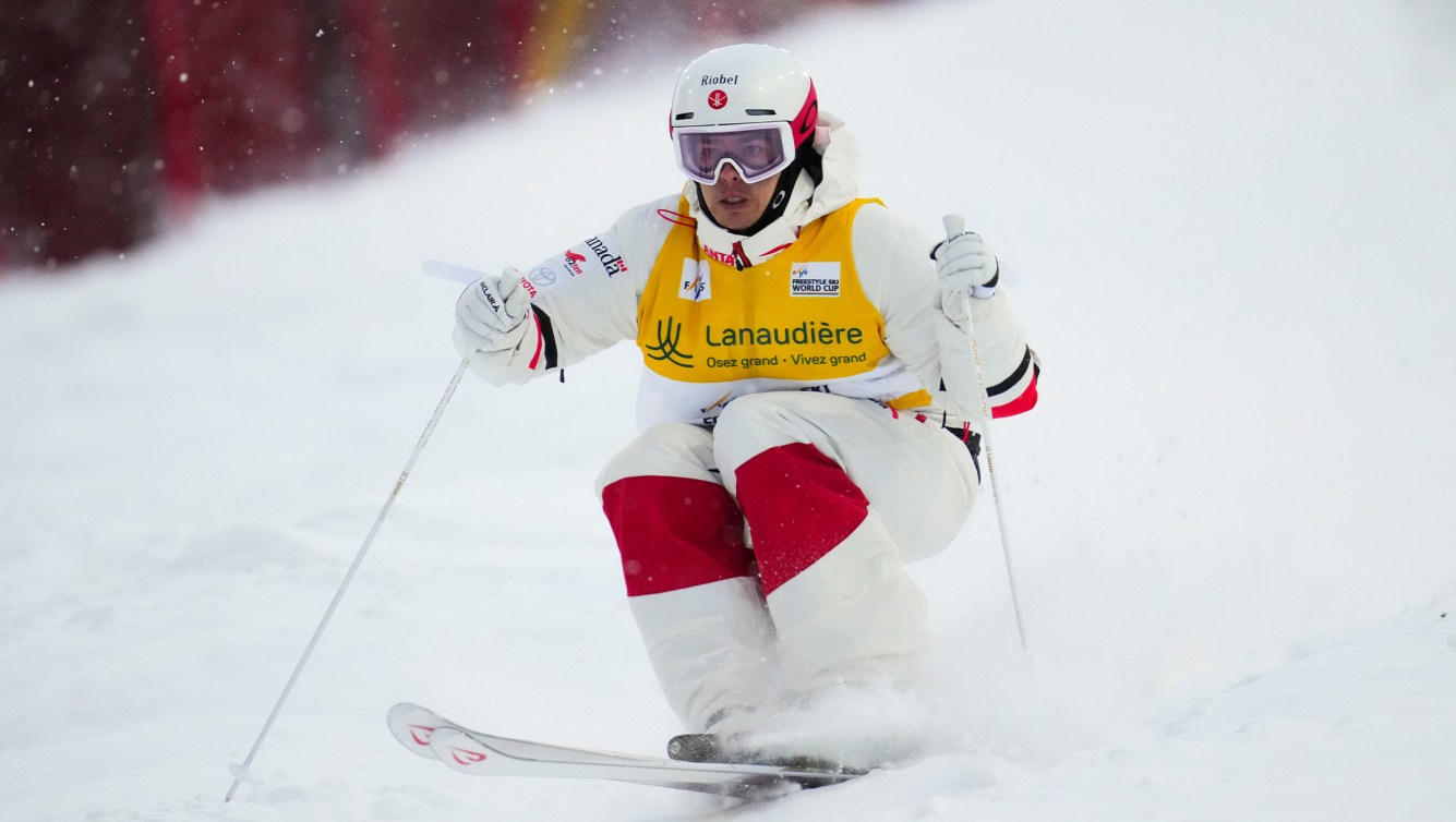 A male moguls skier makes his way down the hill for Team Canada. 