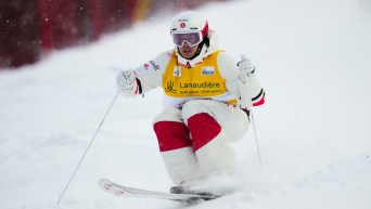 A male moguls skier makes his way down the hill for Team Canada.