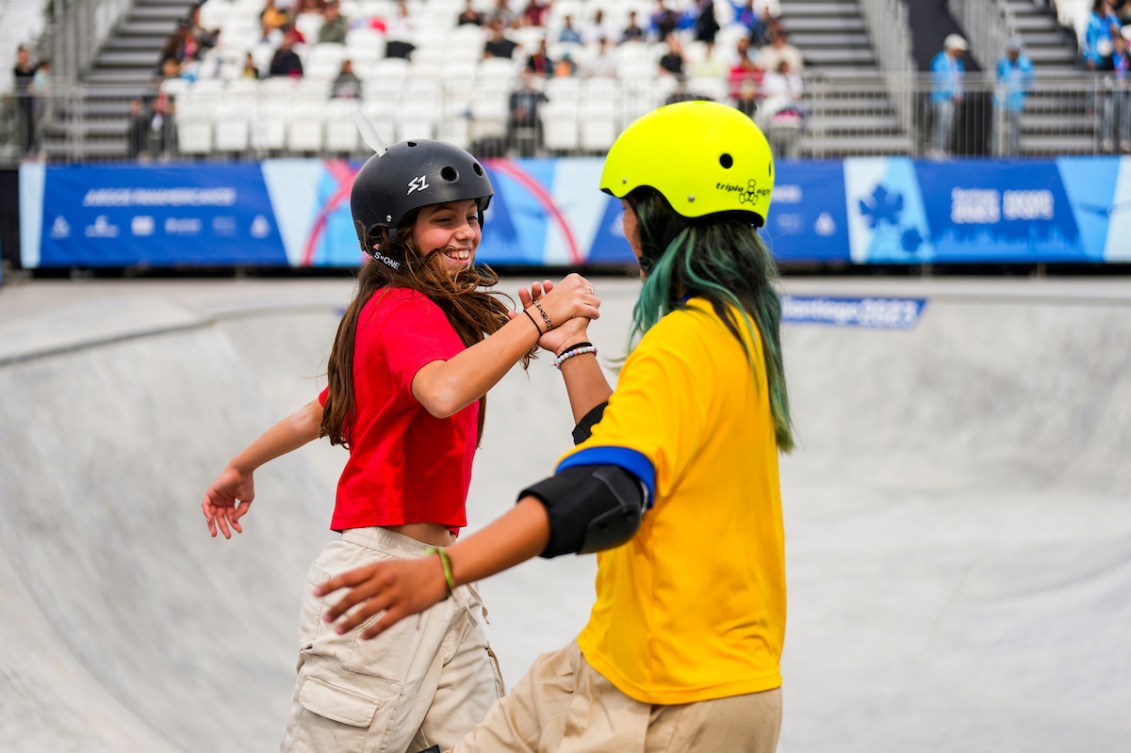 Fay De Fazio Ebert gives a high five to another skateboarder