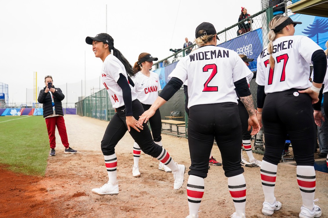 Janet Leung #14 of Canada exits the dugout before facing Peru in Women's Soft Ball action during the Santiago 2023 Pan American
