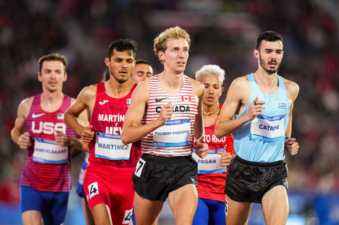 Charles Philibert-Thiboutot runs at the front of a pack of athletes