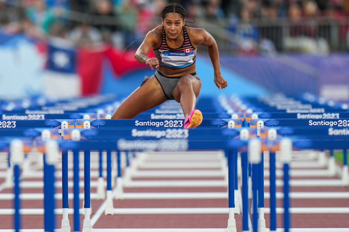 Keira Christie-Galloway hurdles over a barrier