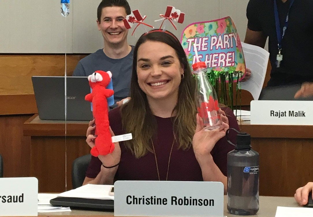 Christine Robinson in the classroom smiling with a happy birthday balloon