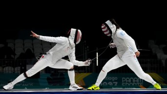 One fencer on the left touches her opponent with her sword tip