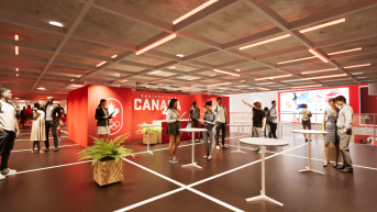 Artist rendering of the interior of Canada Olympic House showing white cocktail tables surrounded by red walls