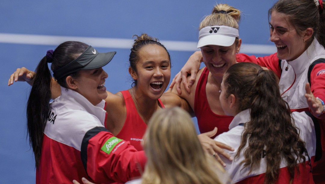 Canada's Gabriela Dabrowski, second from right, and Leylah Fernandez, second from left, celebrate with their teammates after defeating Czech Republic's Barbora Krejcikova and Katerina Siniakova during the semifinal doubles tennis match at the Billie Jean King Cup finals at La Cartuja stadium in Seville, southern Spain, Spain, Saturday, Nov. 11, 2023. (AP Photo/Manu Fernandez)