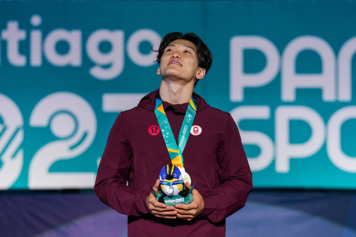 Philip Kim gazes upward after receiving his gold medal at the Santiago 2023 Pan Am Games