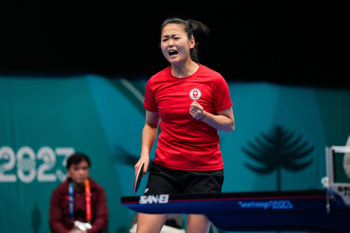 Mo Zhang pumps her fist in celebration
