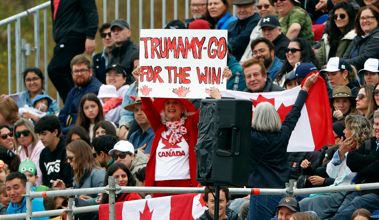 Team Canada fans hold up a sign that says "Trumamy-Go for the win"