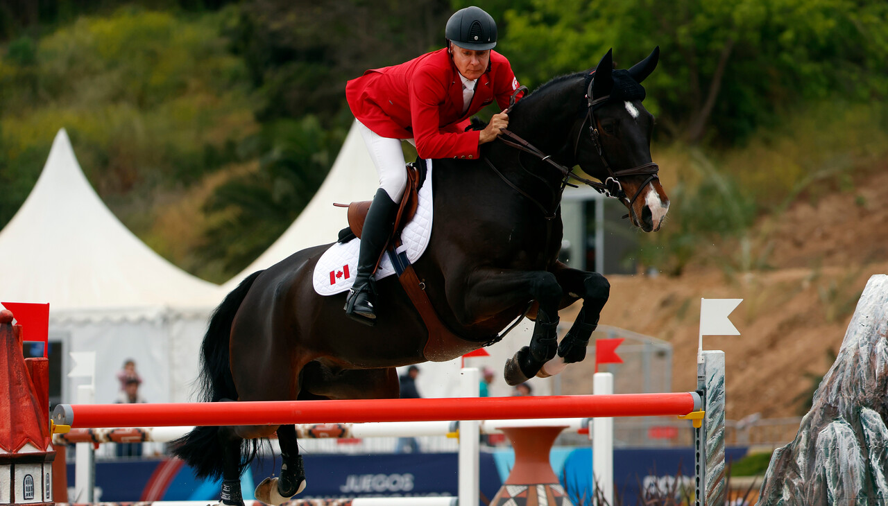 Mario Deslauriers and his horse clear a barrier
