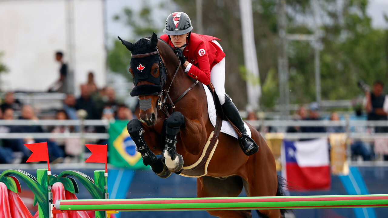 Tiffany Foster and her horse clear a barrier