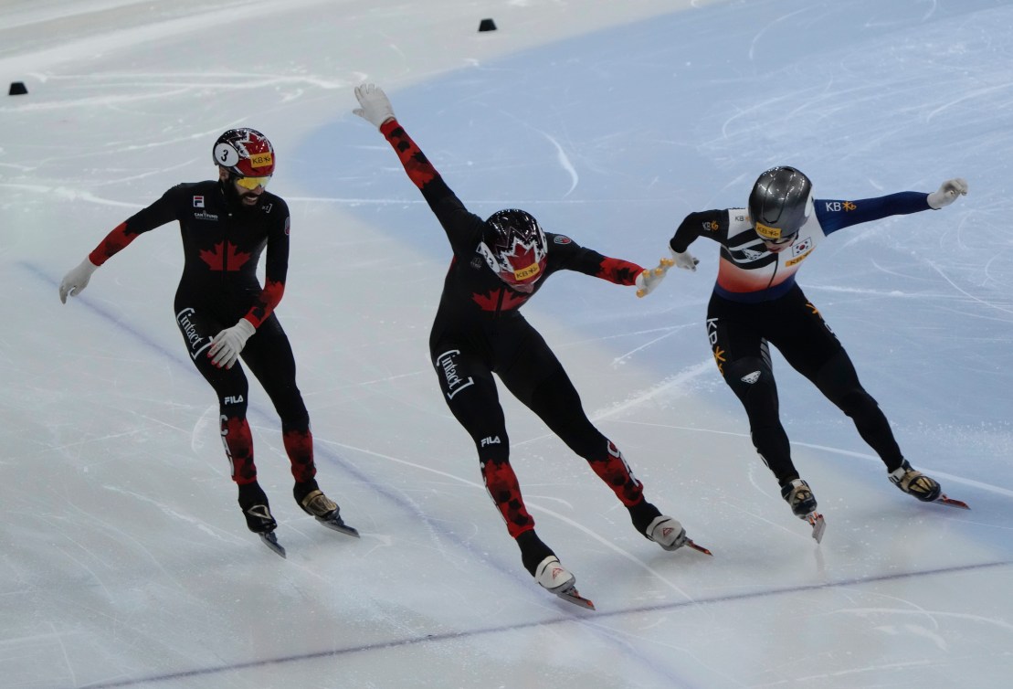 William Dandjinou, center, of Canada and Park Ji-won, right, of South Korea cross the finish line during the final of the men's 1,500-meter (2) at the ISU World Cup Short Track Speed Skating Championships in Seoul, South Korea, Sunday, Dec. 17, 2023. (AP Photo/Ahn Young-joon)