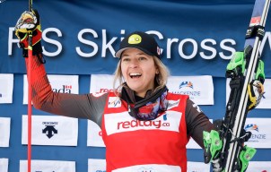 Canada's Hannah Schmidt celebrates her victory on the podium following the women's final of a World Cup ski cross event at Nakiska Ski Resort in Kananaskis, Alta., Saturday, Jan. 20, 2024.