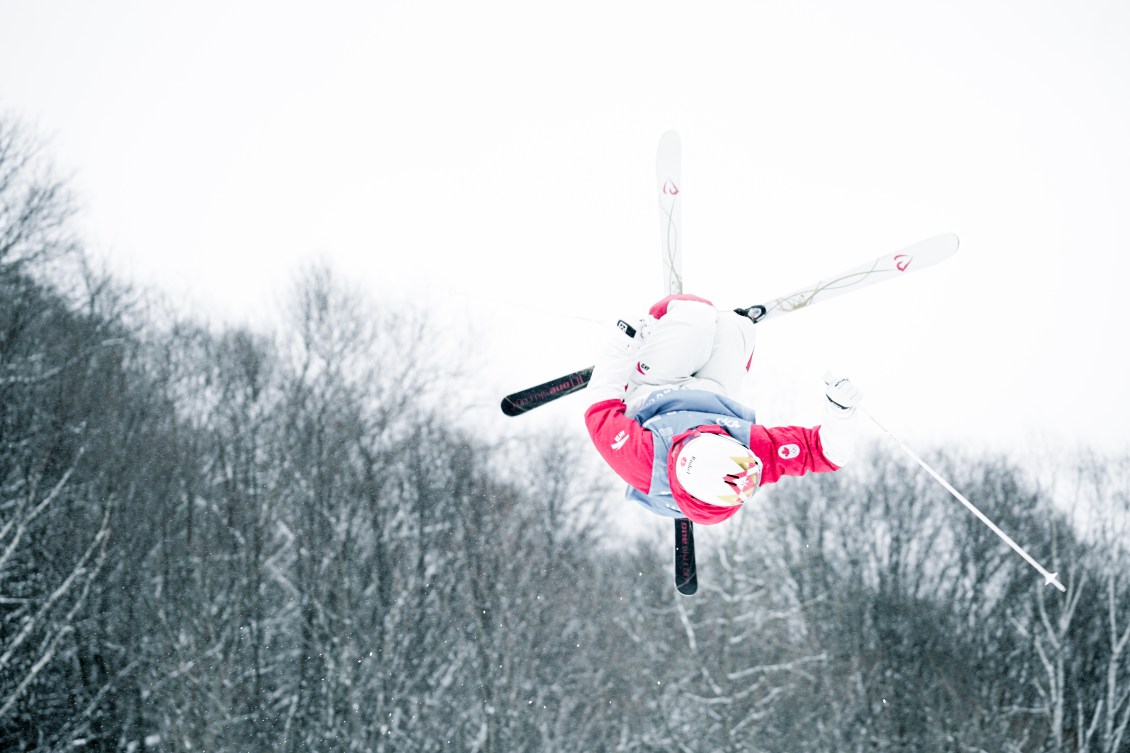 A freestyle skier performs a twist in the air