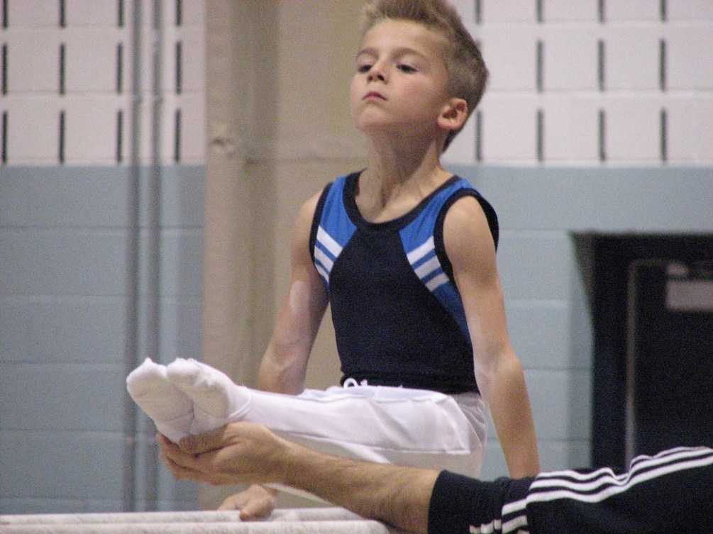 Felix Dolci is assisted by a coach as a child athlete