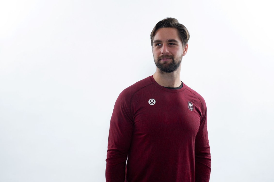 Olympic paddler Pierre-Luc Poulin stares off camera while wearing a red Team Canada shirt