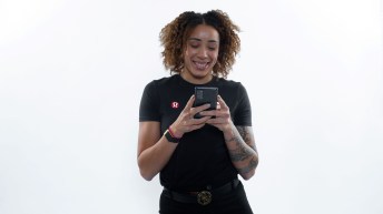 Olympian Tammara Thibeault smiles while looking at her phone