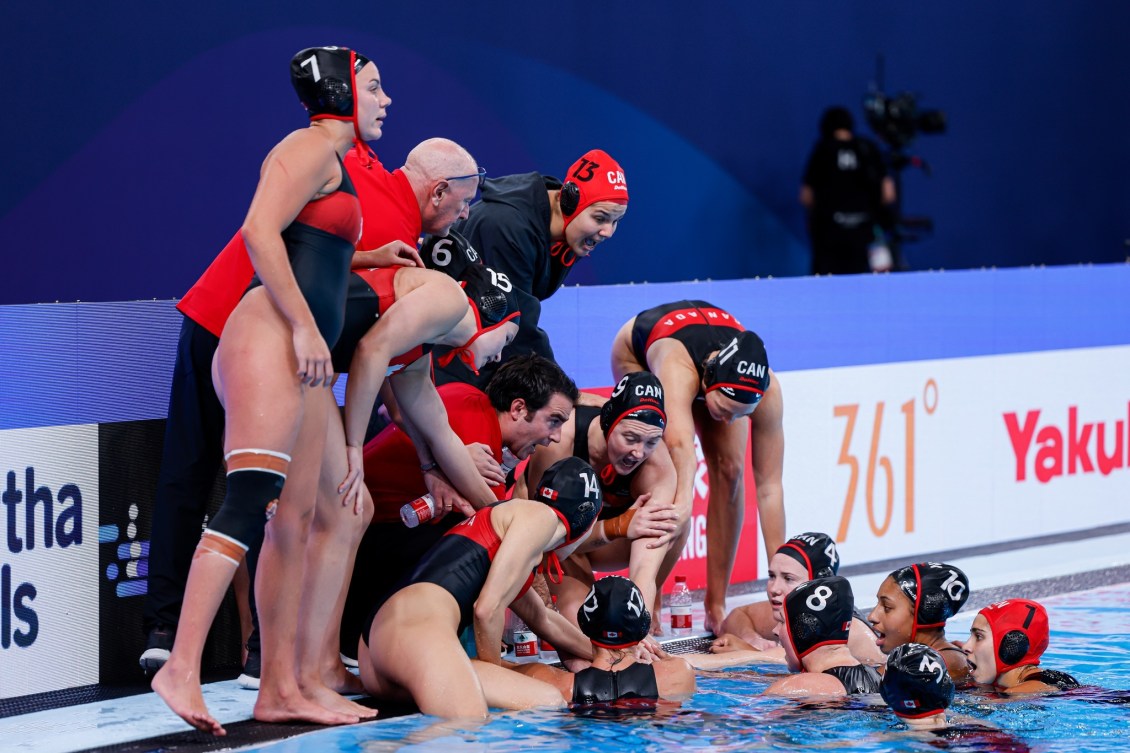 The women's water polo team in the water. 