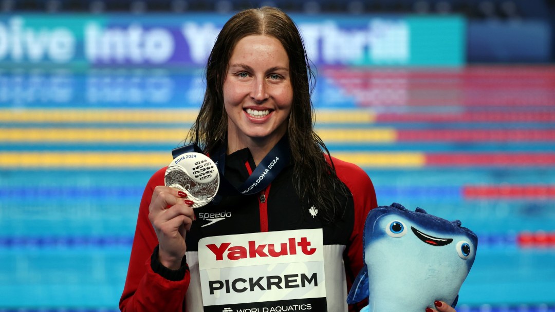 Sydney Pickrem holds up a silver medal for the camera