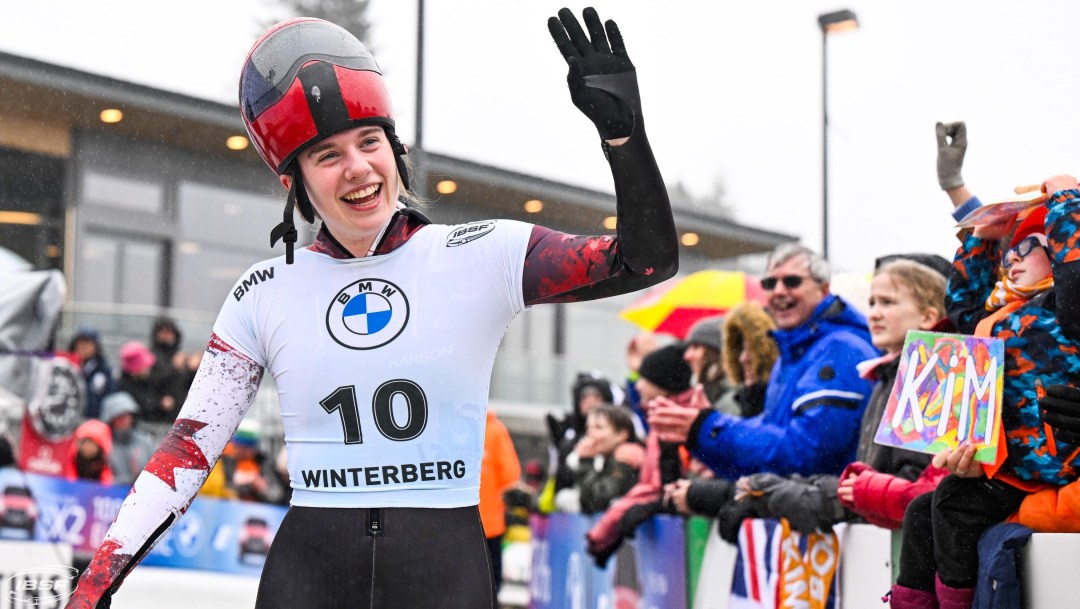Skeleton athlete Hallie Clarke waves to fans after winning the 2024 IBSF World Championships