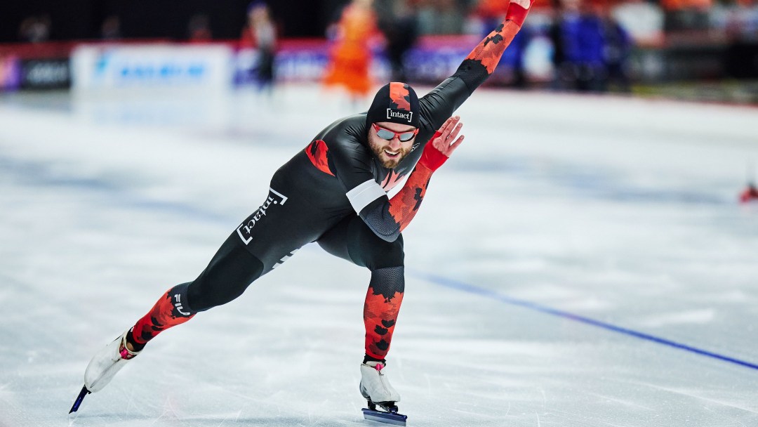 Laurent Dubreuil in a black and red skin suit competes in a speed skating race