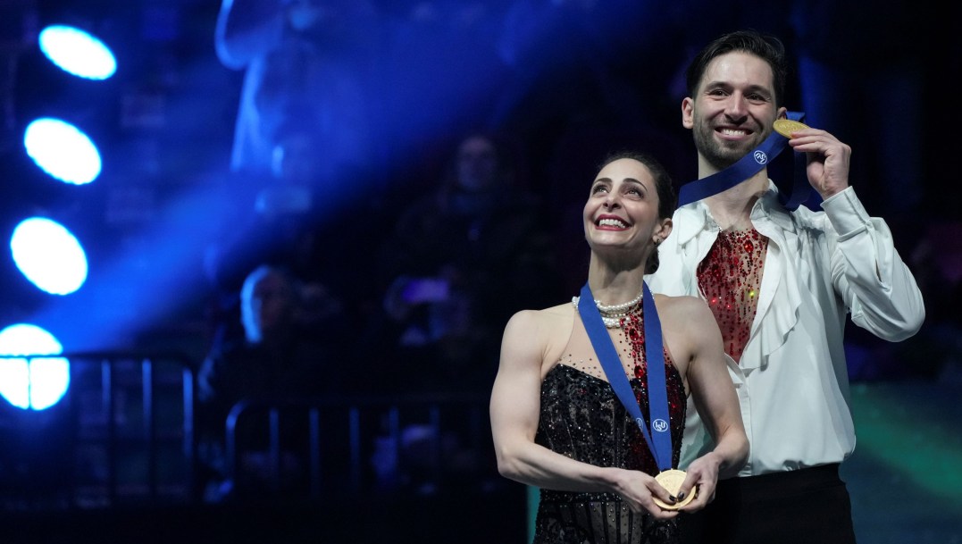 Deanna Stellato-Dudek and Maxime Deschamps wear their gold medals and smile