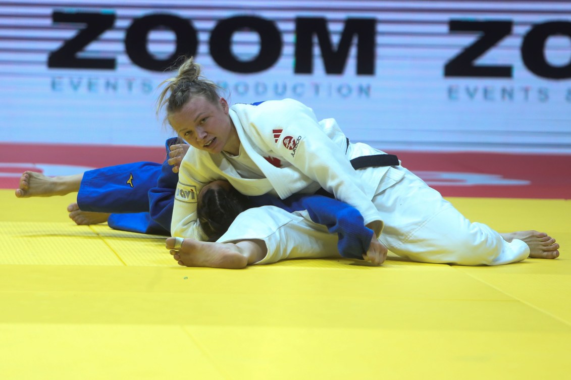 Jessica Klimkait of Canada, top, and Hasret Bozkurt of Turkey compete during their women's -57 kilogram bronze medal judo match at the World Judo Championships in Doha, Qatar, Tuesday, May 9, 2023. (AP Photo/Hussein Sayed)