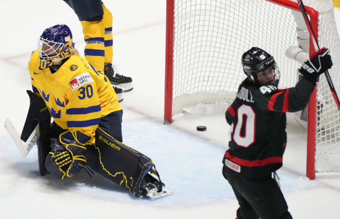 Canada's Blayre Turnbull celebrates a goal by teammate Laura Stacey in front of Sweden goaltender Emma Soderberg during first period quarterfinal action at the IIHF Women's World Hockey Championship in Utica, N.Y., Thursday, April 11, 2024.
